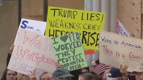 Federal workers protest outside Tesla showroom in San Francisco; Musk defends cuts